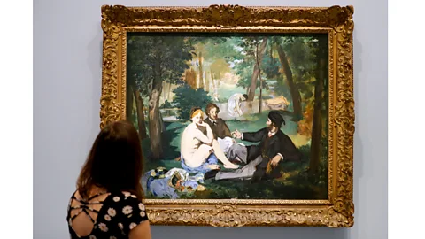 Getty Images Another of ArtActivistBarbie’s subjects is Manet’s Le Déjeuner sur l’Herbe, where a female nude is accompanied by two fully-clothed men (Credit: Getty Images)