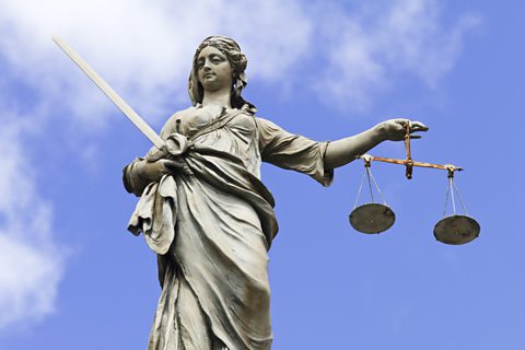 Statue of Justitia holding the Scales of Justice.