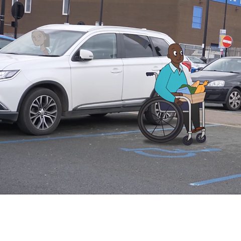 A man in a wheelchair is out of his car in a parking lot