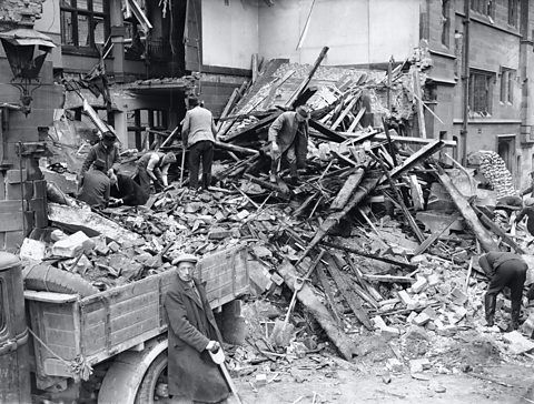 Rescue workers searching through the wreckage of a police station in Coventry following the Luftwaffe air raid on 8th April, 1941