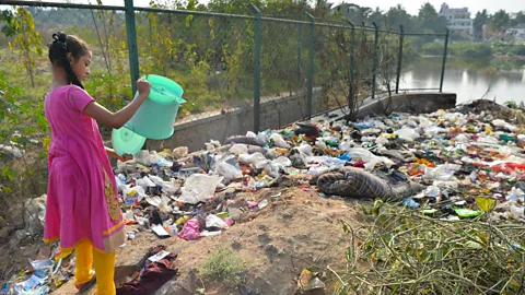 Getty Images Problems with waste dumping and pollution at surface lakes cause a problem for finding drinking water in Bangalore (Credit: Getty Images)