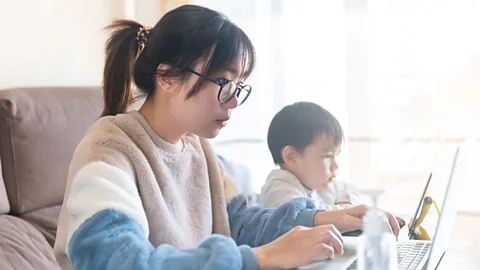 Alamy Closures of childcare facilities and schools have left many women juggling work and family