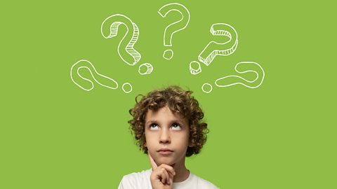 A boy is thinking about questions to ask in a questionnaire