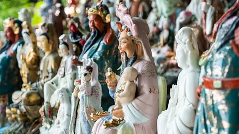 Ian Hinchliffe/Alamy A devout Buddhist, Wong looks after deities of all faiths and couldn't bear to see them neglected (Credit: Ian Hinchliffe/Alamy)