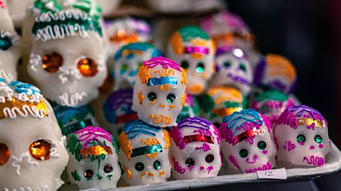 A tray of colourful sugar skulls,