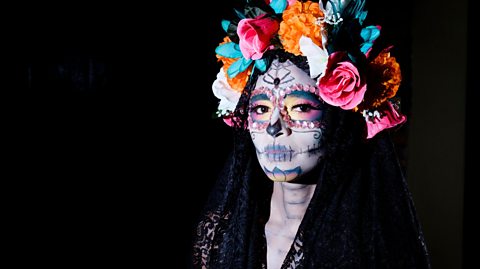 A woman in la catrina makeup.