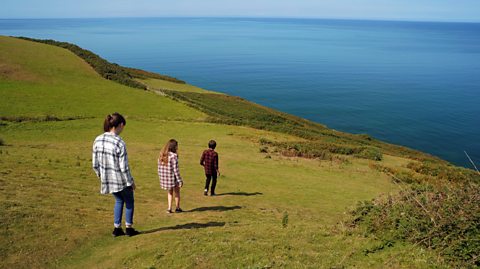 Kids trekking over a hill