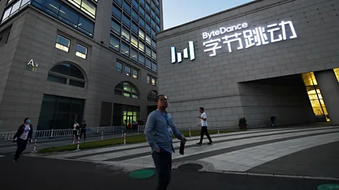 Greg Baker/Getty Images People walk past the Beijing headquarters of ByteDance, which owns TikTok, in September 2020 (Credit: Greg Baker/Getty Images)