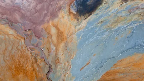 Peter Adams/Getty Images Mixed with water, the iron minerals spread like watercolour paint across the landscape (Credit: Peter Adams/Getty Images)