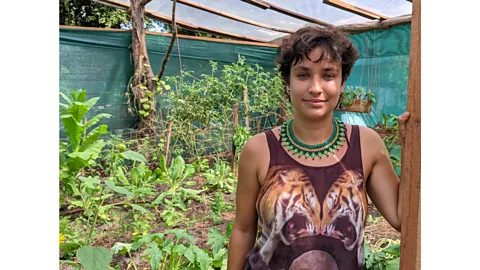 Jocelyn Timperley Mariel Romero Mendez, AstilleroVerde coordinator, stands by the organisation's garden, where produce such as mango, avocado, and tomatoes are grown (Credit: Jocelyn Timperley)