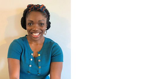 Kemi Omijeh smiling and wearing a blue blouse with buttons on it. Kemi has a colourful headband.