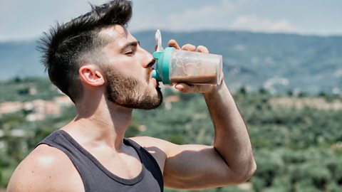 Muscly man drinking a protein shake