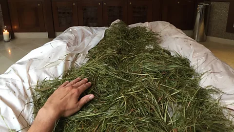 Mike MacEacheran Heubad, which involves being wrapped in pre-boiled mountain grass for around 20 minutes, has seen a boom in recent years (Credit: Mike MacEacheran)