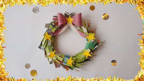 A Christmas wreath made from newspaper.