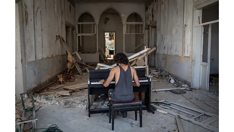 Chris McGrath/Getty Images Raymond Essayan plays a piano in a destroyed building on 14 August, 2020 after the port explosion in Beirut, Lebanon (Credit: Chris McGrath/Getty Images)