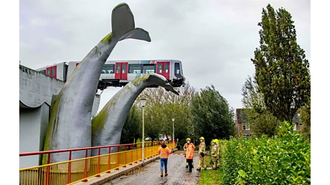 Robin Utrecht/ANP/AFP via Getty Images A crashed train rests on a sculpture called Saved by the Whale's Tail in the Netherlands, November 2020 (Credit: Robin Utrecht/ANP/AFP via Getty Images)