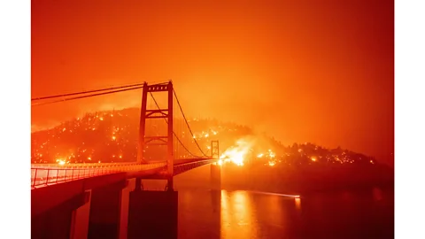 Josh Edelson/AFP via Getty Images The Bidwell Bar Bridge is surrounded by fire in Lake Oroville, California, September 2020 (Credit: Josh Edelson/AFP via Getty Images)