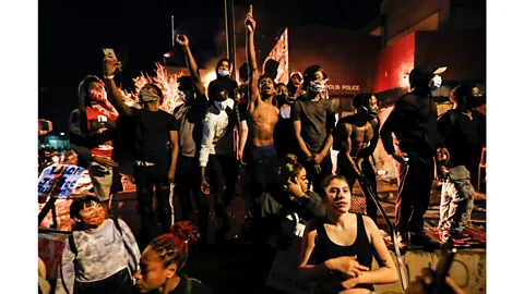 John Minchillo/AP Protesters demonstrate beside a police station in Minneapolis, Minnesota on 28 May, 2020, after the death of George Floyd in police custody (Credit: John Minchillo/AP)