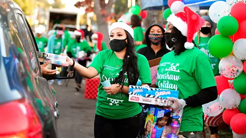 Frederic J Brown/Getty Images Spending your money on others rather than yourself has been linked to a wide range of better health outcomes (Credit: Frederic J Brown/Getty Images)