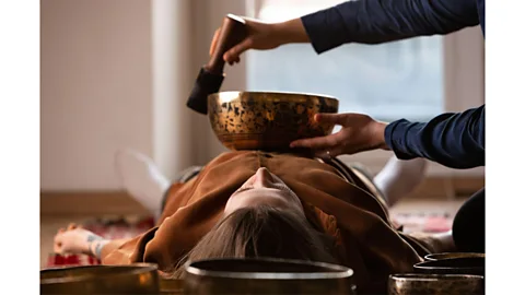 Spiritual girl playing Tibetan gong Stock Photo - Alamy