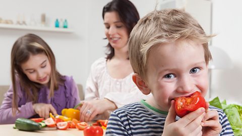 A family eating fruit and vegetables together