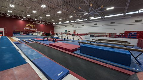 The Beyer Hall gymnastics training facility at Iowa State University, with red walls and blue equipment