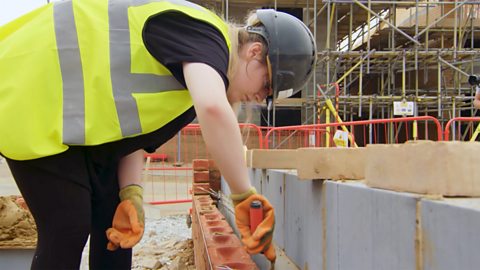 Allina working on bricklaying a wall