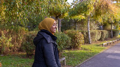 A young woman on a walk in the park.