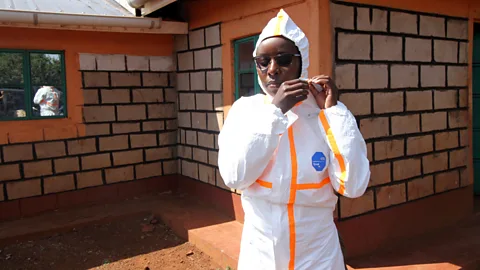 Jacob Kushner Millicent Minayo and her colleagues have to wear full protective clothing while taking samples in the villages (Credit: Jacob Kushner)