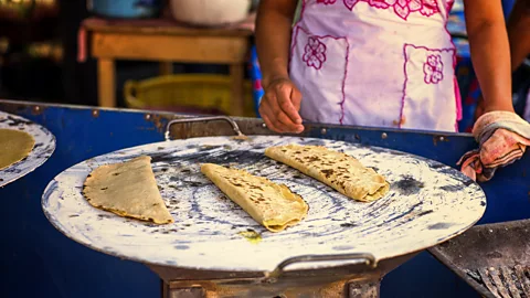 fitopardo/Getty Images In Mexico, fresh corn tortillas are used for dishes like quesadillas, made here on a comal (Credit: fitopardo/Getty Images)
