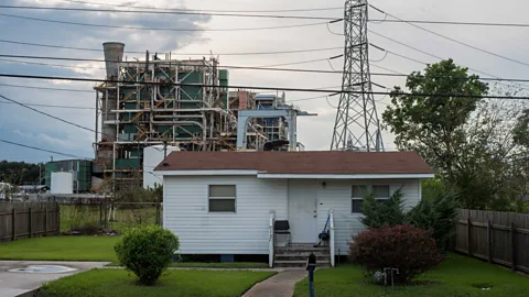 Giles Clarke/Getty Images Not far from the Mississippi River, a home in Louisiana sits side-by-side with a chemical plant and pylon (Credit: Giles Clarke/Getty Images)