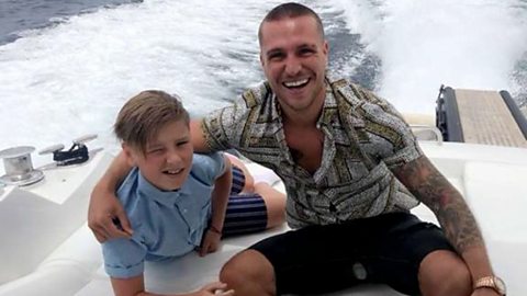 Tom Zanetti and his son Deaconn on a speedboat.