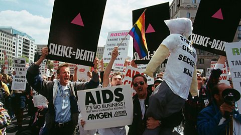 ACT UP activists at the Capitol in the USA in 1993, holding signs with an upward-facing pink triangle.