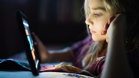 A girl using a tablet to go online