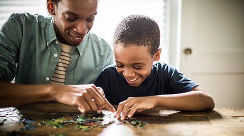 Father and son with jigsaw puzzle