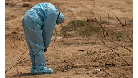 Danish Siddiqui/Reuters In a graveyard in India, a health worker reacts before a funeral (Credit Danish Siddiqui/Reuters)