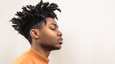 Young man with eyes shut looking peaceful.