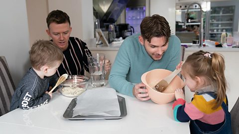 Kieron Richardson, his husband Carl and children Phoebe and Chase baking together.