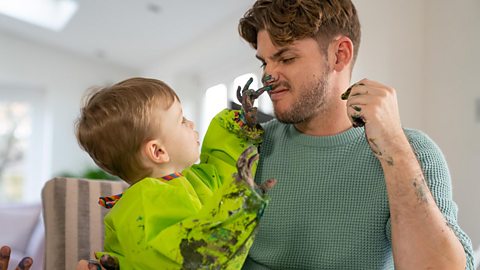 Kieron with son Chase - Chase is putting finger paint on Kieron's nose.