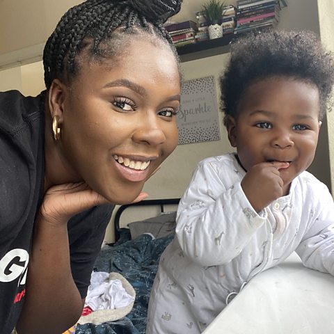 Millie and Cairo taking a selfie in a bedroom. They are both smiling.