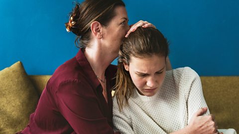 Mother comforts daughter