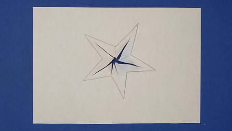 A star shape on paper with cuts made from the centre to each corner