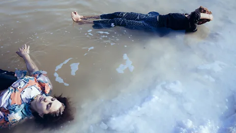 Solmaz Daryani Women bathe in a remant of the lake in 2014, in a remote region of Lake Urmia that now receives few visitors (Credit: Solmaz Daryani)
