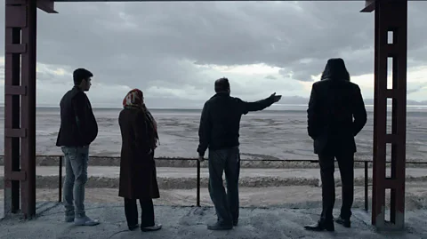 Solmaz Daryani After a period of rains, a hotel proprietor shows his guests how much closer the lake has come to his establishment (Credit: Solmaz Daryani)