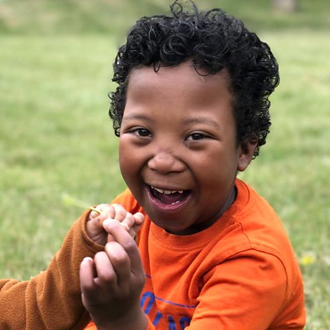 Adam smiling at the camera.