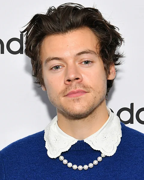 Getty Images Harry Styles often plays with gender stereotypes in his choice of jewellery and outfits (Credit: Getty Images)
