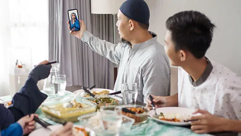 Alamy Doing something while you're Zooming, like preparing and sharing a family meal, can potentially minimise the unnatural-feeling, draining effects of video calls (Credit: Alamy)