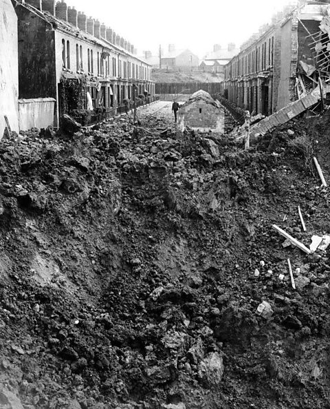 A giant crater left by a parachute mine shows the devastating power of the bombers (copyright Belfast Telegraph)