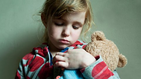 Little girl hugging her teddy bear