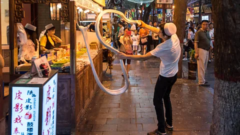 Paul Martin/Alamy In downtown Xi'an, chefs are commonly seen slapping and stretching pasta dough into incredibly long strands (Credit: Paul Martin/Alamy)
